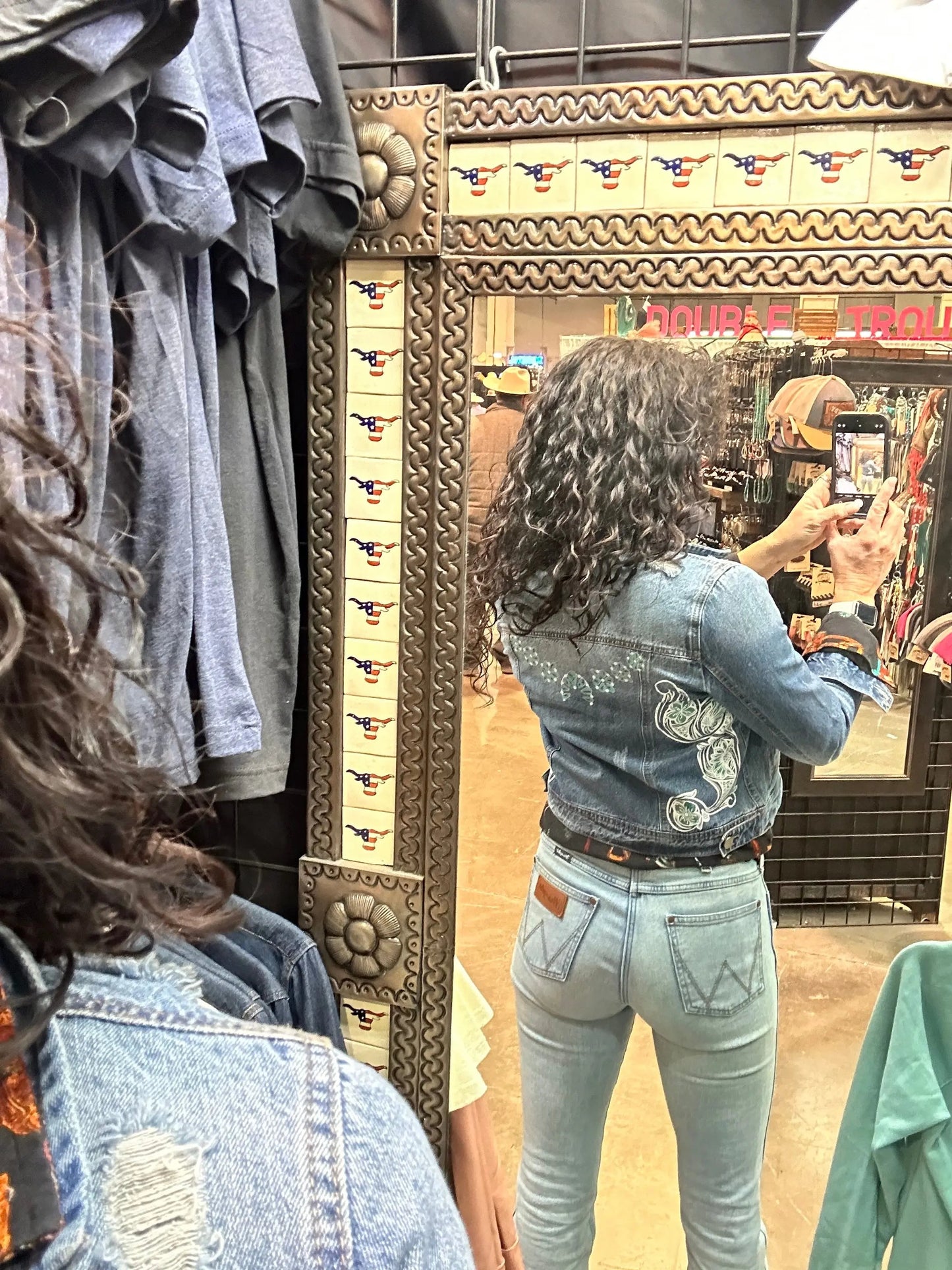 Denim jacket with Squash Blossom and tooled sides.